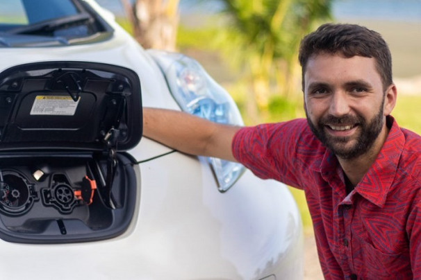 Alex Reddaway, owner and Director of Capital Leaf, with an electric Nissan Leaf in Suva.  